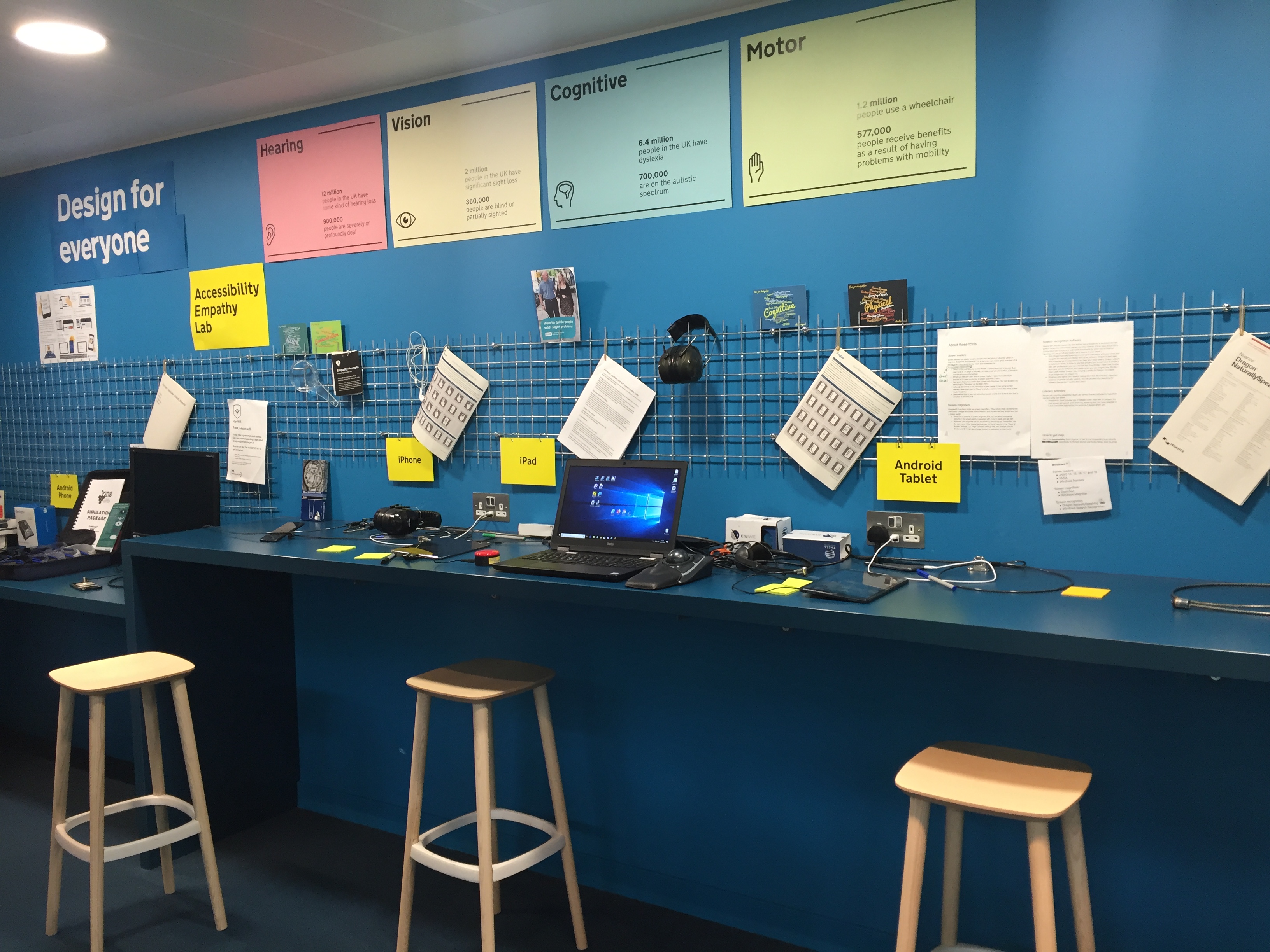 The accessibility empathy lab at GDS with computers, accessibility equipment and posters.