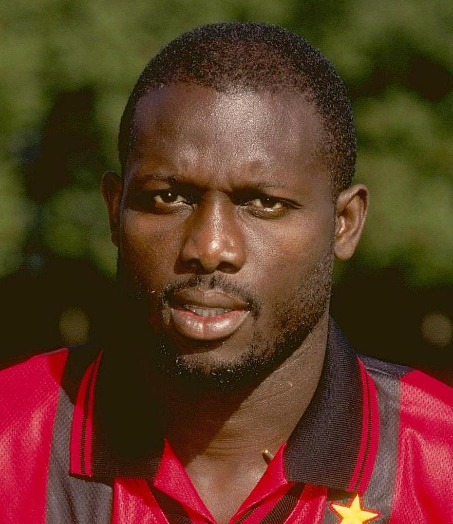 Profile picture of footballer George Weah in an AC Milan jersey.