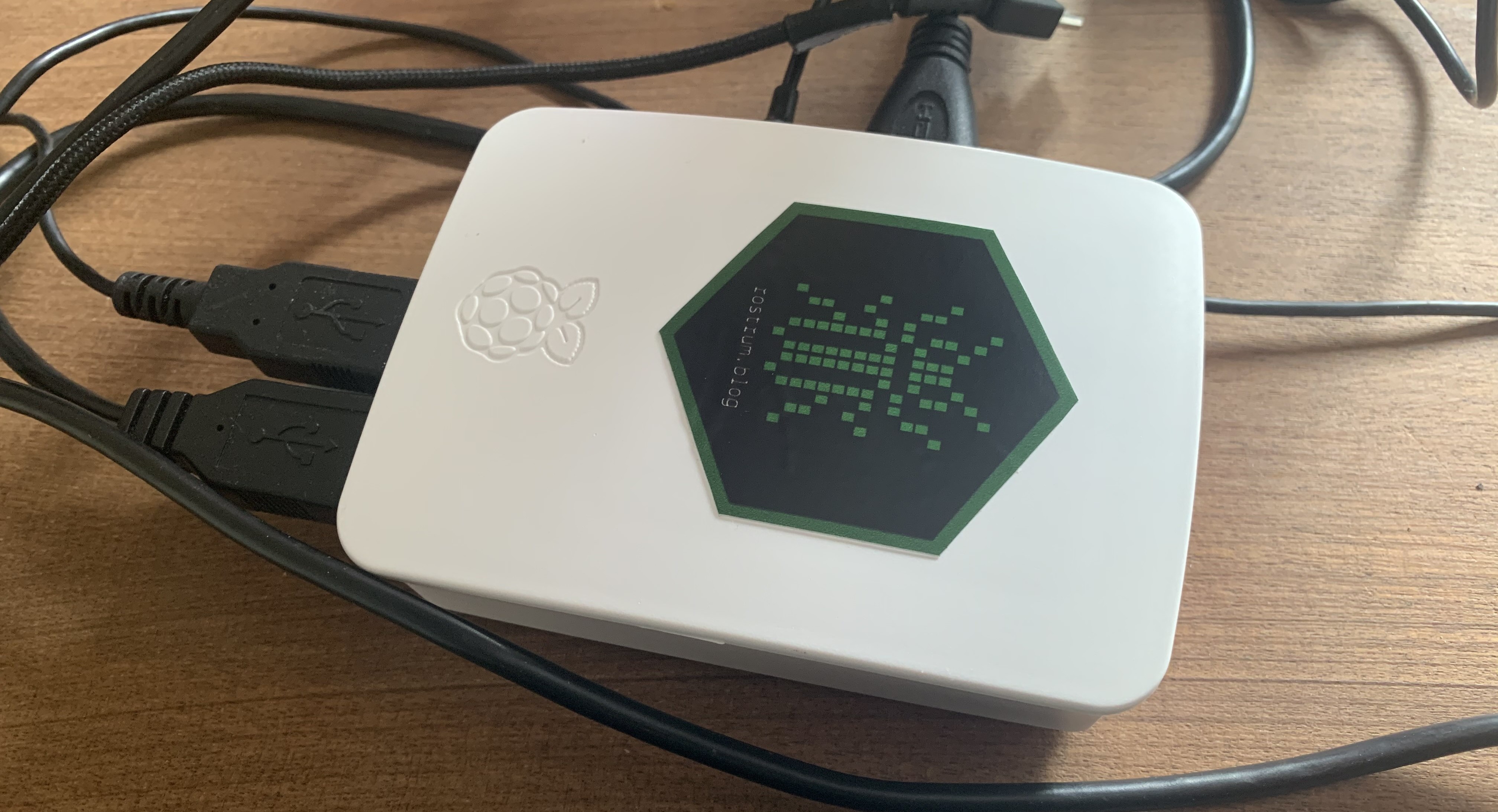 My Raspberry Pi 2 Model B housed in a white plastic case with a rostrum.blog sticker on the top.