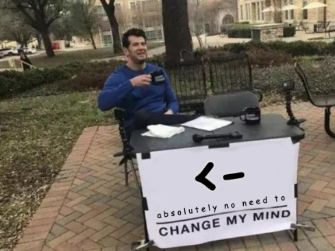 A man sits at a table with a banner that has on it R's left assignment operator (<-) and underneath it says 'change my mind'.