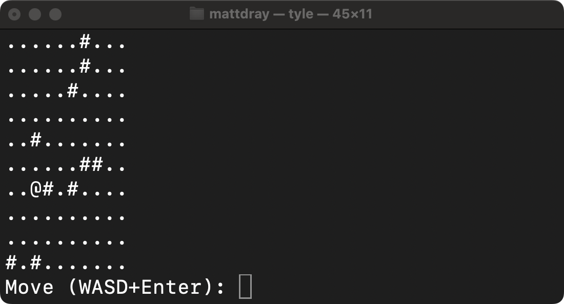 A 10 by 10 grid of characters printed to a macOS terminal. Tiles are mostly period characters, with some hashmark characters, and an at symbol near the middle. A prompt underneath reads 'Move (WASD)+Enter:', ready for user input.